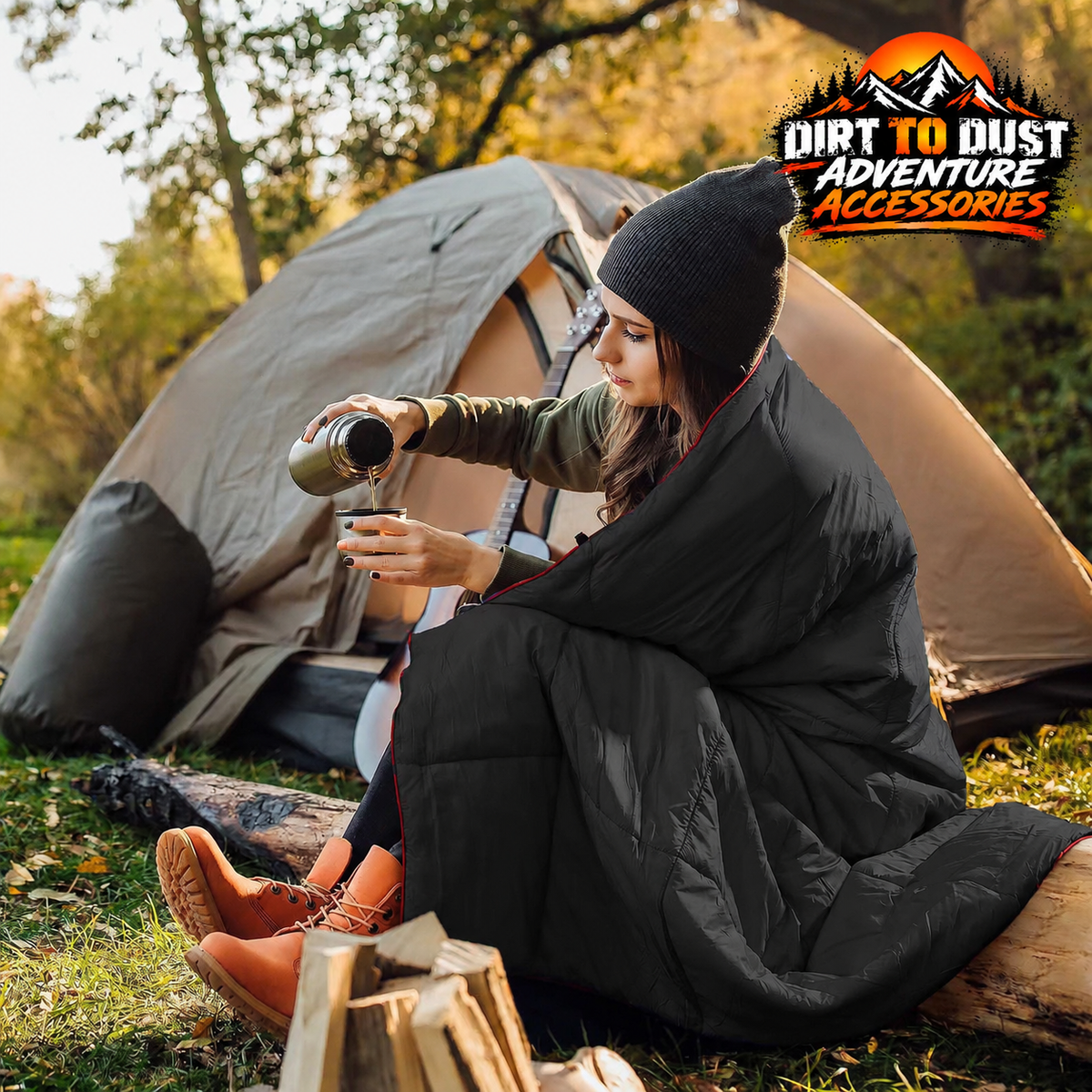 Black quilted camping blanket worn as a wrap at a campsite