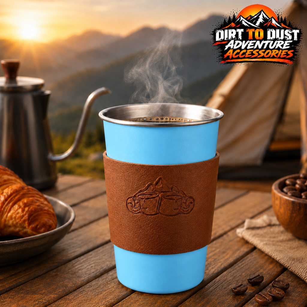 Tall blue 500 ml camping cup with tan removable sleeve on a campsite table.